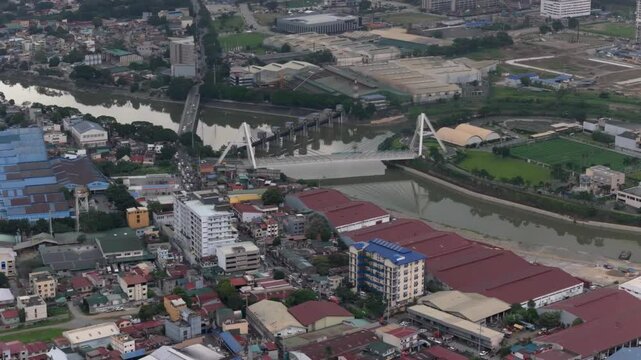 An establishing shot of Circulo Verde Bridge at Quezon City during the day
