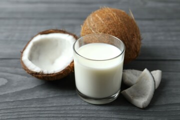 Glass of coconut milk on wooden background 