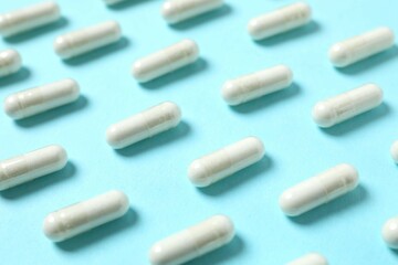 White capsules on a color background