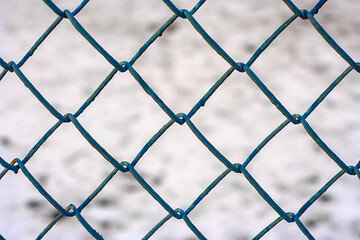 blue wire mesh fence and snow