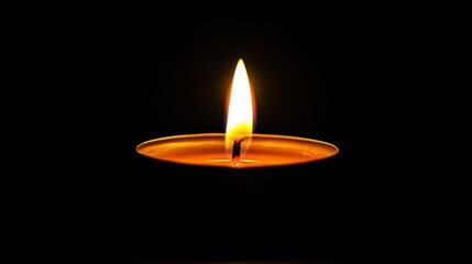 Single candle flame in dark.