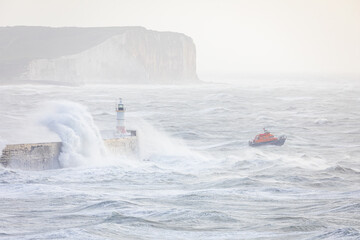 Storm bert crashing into Newhaven lighthouse on the east Sussex coast south east England UK