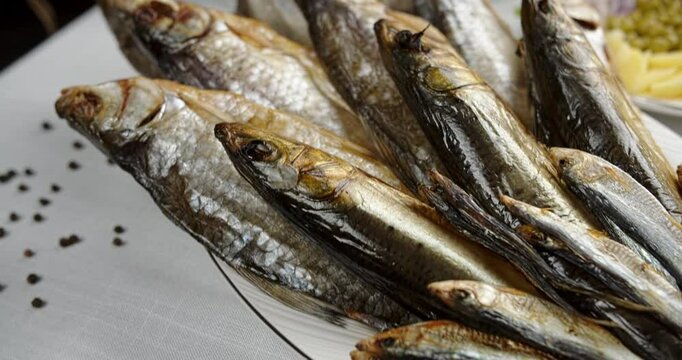 dried fish lies fanned out on a plate, restaurant national food