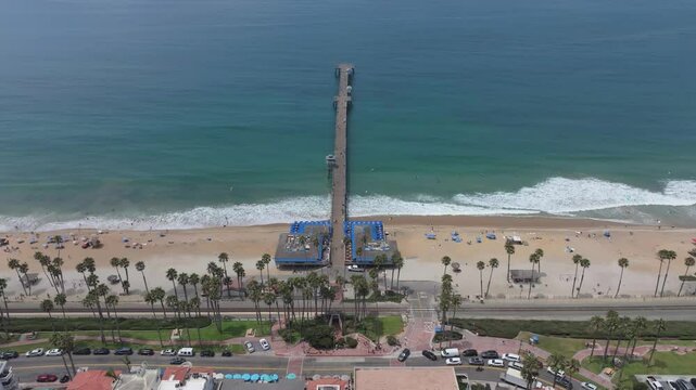 Panoramic footage of San Clemente pier from coastline looking to ocean