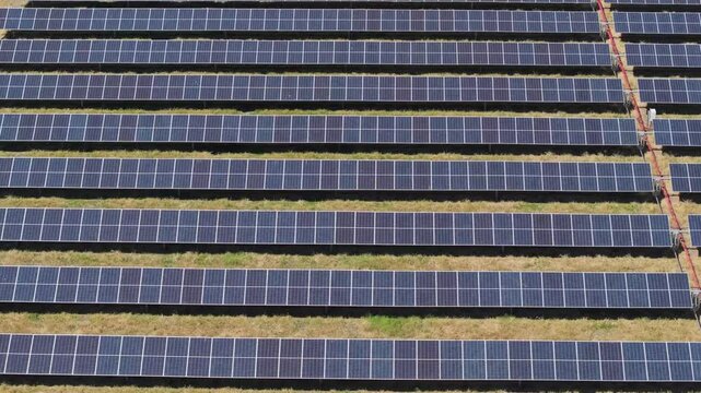 aerial to direct overhead view of symmetrical solar panel rows