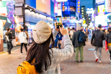 Young woman traveler enjoying and shopping at Shibuya street in Tokyo, Travel lifestyle
