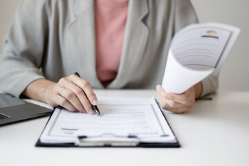 Business woman employer holding resume hiring recruit looking cv resume to hire candidates, analyzing information before job interview. Recruitment concepts