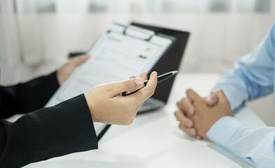 Business people hold a resume and talk to job applicants for job interviews about careers and Their personal history in the company. Recruitment concepts