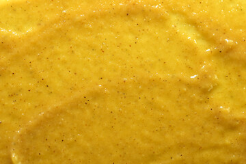 Background and texture of hot mustard seasoning taken at close range.