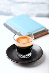 Coffee in glass cup on bright wooden background. Copy space.	