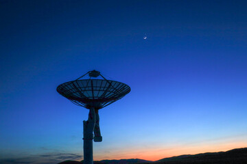 Astronomical telescope equipment, silhouette at sunset