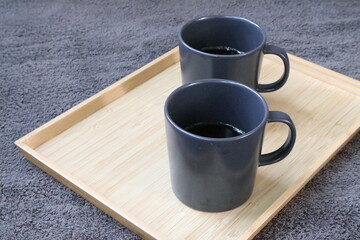 Empty coffee cup and spoon on wooden cutting board