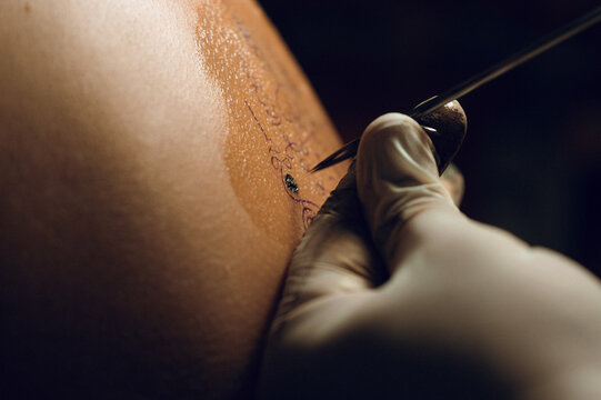Buddhist monk doing traditional Buddhist Thai Sak Yant tattoo