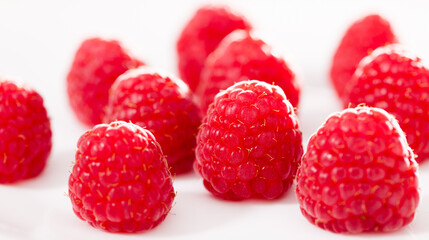 Handful of raspberry berries on white background