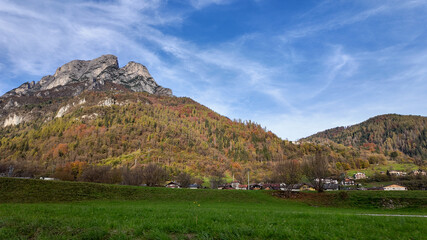 Vibrant autumn foliage blankets a picturesque mountain village in the Alps, symbolizing tranquility and the beauty of nature during fall  Dolomite Alps