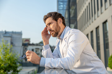 Young doctor having coffee and feeling tired after a night shift