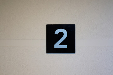 a sign indicating the second floor of a building