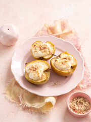 Three apples with a white cream filling on a pink plate