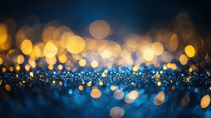 Glittering gold bokeh lights floating against deep blue background, magical and festive atmosphere, perfect for celebrations or holiday themes.