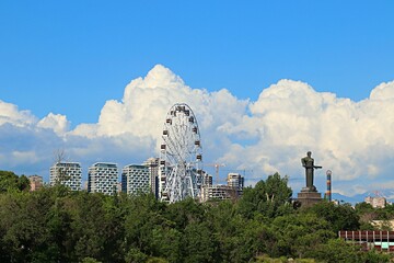 Fototapeta premium Yerevan, Ferris wheel and Mother Armenia statue in the city park