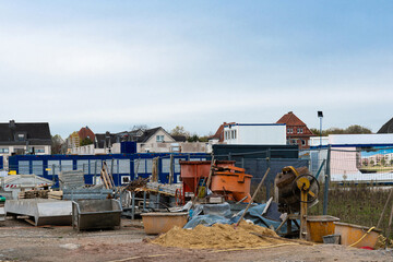 Construction site with various materials and equipment in urban area