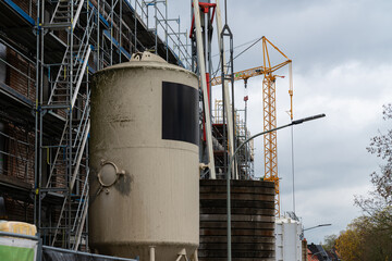 Construction site showing cement mixer and scaffolding in progress