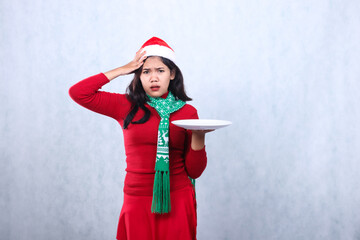 expression of asian woman wearing red sweater red sweater with santa hat and scarf celebrating...