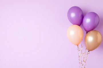 Colorful balloons floating on a pastel purple background for celebration