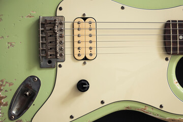 Classic green electric guitar with a vintage design, isolated on white. Ideal for music-themed...