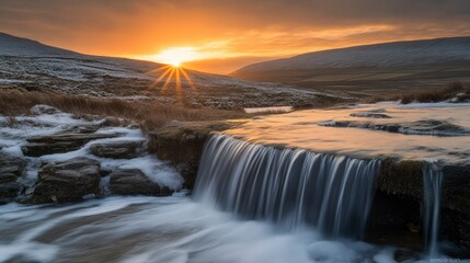 Obraz premium Tranquil Landscape with Sun Setting Over a Waterfall in a Serene Natural Environment, Capturing the Beauty of Nature and Calm Waters Flowing Over Rocks