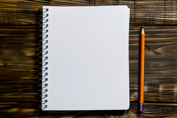 Simple and inspiring workspace for creativity and productivity, white spiral notepad and orange pencil on a textured wooden table with blank pages