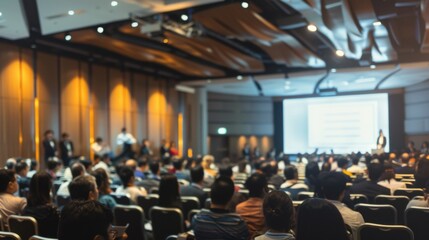 A high-resolution image of a business seminar with a keynote speaker presenting on stage, and the audience attentively watching, The seminar space features sophisticated lighting and modern design