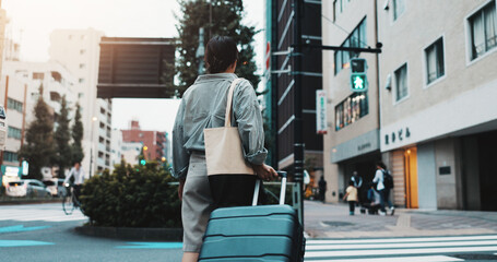 Walking, suitcase and woman in city for travel with international exchange student program....
