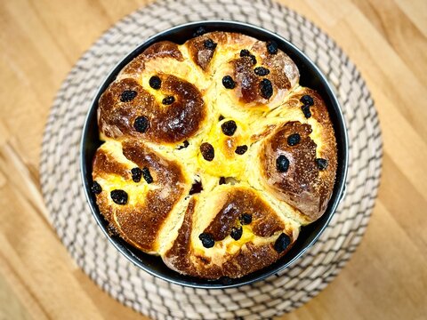 Close-up overhead view of a traditional homemade Bulgarian Easter sweet bread (Kozunak) on a wooden table