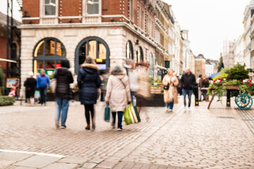 Busy shopping street scene with motion blur