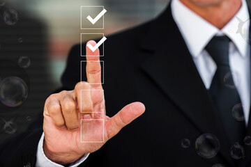 Businessman touches a digital progress checklist with check marks and an advancing loading bar,...