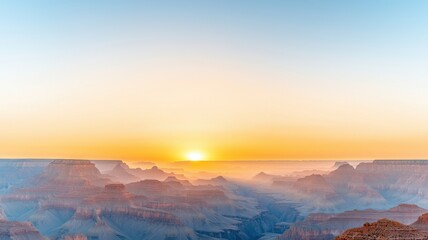 Naklejka premium Sunrise over rugged canyon landscape with soft pastel colors.