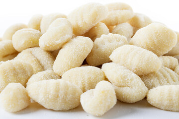 Tasty raw gnocchi isolated on white background