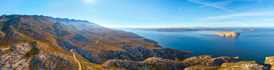 Panorama of mountain range Northen Velebit and Adriatic Sea in Croatia. Majestic mountain landscape. Aerial view of Adriatic coastline. Travel in Croatia, road trip