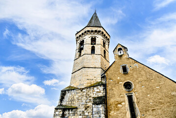 Fototapeta premium Church of San Miguel in Romanesque-Gothic style, in Viella, Valle de Aran, Catalonia, Spain, under a blue sky with white clouds