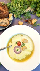 Golden lentil soup surrounded by vibrant seasonal vegetables celebrates ecological farming. Rustic bread enhances fresh, farm-to-table appeal, highlighting vegan, clean-eating benefits.