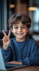 8 years old boy at home sitting in front of laptop showing victory sing with fingers .