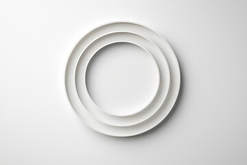 Minimalist White Plates Arranged in Circular Design on White Surface