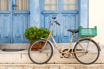 Lonely bicycle with shopping basket on the street in Greece