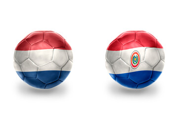 Obraz premium football balls with national flags of netherlands and paraguay ,soccer teams. on the white background.