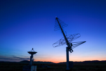 Astronomical telescope equipment, silhouette at sunset
