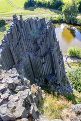 Majestic basalt mountains from which trees grow. Rod-shaped hexagonal stone mountains in the...