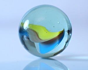 Closeup on colorful marbles on white background