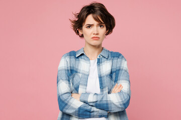 Young sad serious frowning woman wear blue shirt white t-shirt casual clothes hold hands crossed...