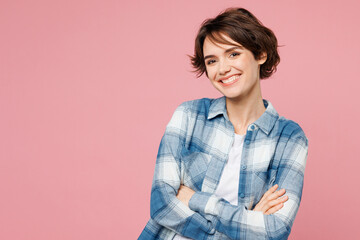 Young smiling happy cheerful woman wear blue shirt white t-shirt casual clothes hold hands crossed folded look camera isolated on plain pastel light pink background studio portrait. Lifestyle concept.